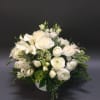 White floral arrangement in a low round container