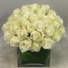 Cream rose bouquet in a square glass vase