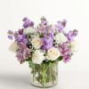Lavender and white mixed bouquet in a clear glass vase