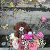Teddy bear in a box with pink and blush roses