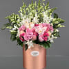 Pink and white floral arrangement in a rose-gold cylindrical box