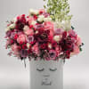 Pink and burgundy roses with orchids in a white box