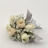 Small bouquet of cream roses and white filler flowers with silver ribbon