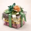 Gift box with flowers on top and wrapped chocolates inside