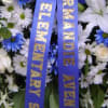 White and blue funeral wreath with a purple ribbon