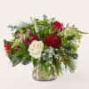 Mixed bouquet with white and red roses in a clear glass vase
