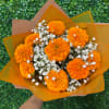 Orange marigold bouquet with white baby's breath in orange wrap
