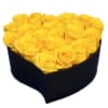 Yellow roses arranged in a black heart-shaped box