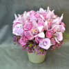These Lavender and Purple Roses with Cymbidium Orchids and Wax flowers in