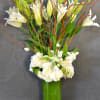 Tall clear vase with Lilies, roses, tulips and hydrangeas. 