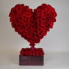 enchanted her with this amazing heart made of red roses.