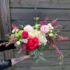 A whimsical bouquet of greenery and flowers