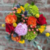 Colorful bouquet of roses, peonies, and green hydrangeas