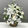 A basket of white lilies, roses, and matsumoto asters to honor the