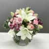 Tones of blush and mauve touch upon white lilies for a playful