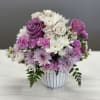 Bouquet of pink, purple, and white flowers in a striped vase