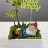 Succulent planter with a reclining gnome and a happy birthday topper