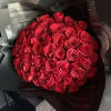 Bouquet of red roses wrapped in black paper