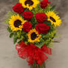 Bouquet of red roses and yellow sunflowers in a glass vase with a red ribbon