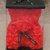 Red rose teddy bear in a clear gift box with a black ribbon