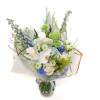 Bouquet of white, blue, and green flowers in a glass vase