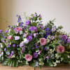 Our casket spray flowers are meticulously crafted arrangements specifically designed to rest