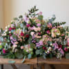 Our casket spray flowers are meticulously crafted arrangements specifically designed to rest