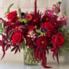 Red roses and burgundy dahlias in a clear glass vase
