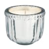 Clear glass candle holder with a white candle inside