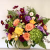 Colorful mixed flower arrangement in a low ceramic vase