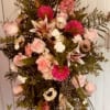 Tall pink and white floral standing spray on an easel