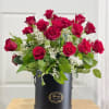 Red roses arranged in a black hat box with baby's breath