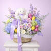 A charming Easter basket featuring a mix of roses, tulips, hydrangeas, and