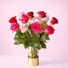 English:
Premium long-stem rose arrangement in fuchsia, pink, and red tones, presented in