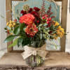 Mixed bouquet in a glass vase with a burlap bow
