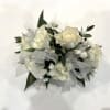 Creamy white roses gathered into a compact corsage create an elegant, romantic