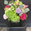 A stunning combination of hydrangeas, roses, tulips, scabiosa, cymbidum orchid and cremone
