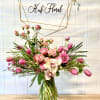 Pink bouquet with roses and tulips in a glass vase