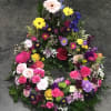 Colorful floral wreath with roses, daisies, and mixed blooms