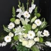 White and green floral arrangement with roses and daisies in a vase