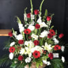Large basket arrangement with red roses, white lilies, and red gerbera daisies