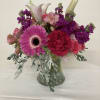 Pink and purple mixed bouquet in a clear glass vase
