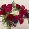 Bouquet of red and pink roses with white flowers and purple accents