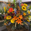 Large mixed floral arrangement with sunflowers, lilies, and gerbera daisies