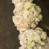 White rose and hydrangea floral garland on a dark surface