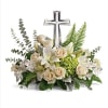 White floral arrangement with a silver cross centerpiece
