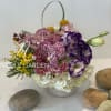 Purple orchids and white hydrangeas in a white basket