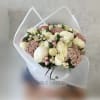 Bouquet of white roses and pink berries wrapped in white paper