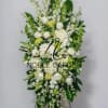 Tall white and green standing floral spray with mixed blooms