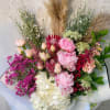 Mixed bouquet with pink peonies, white hydrangea, and red protea